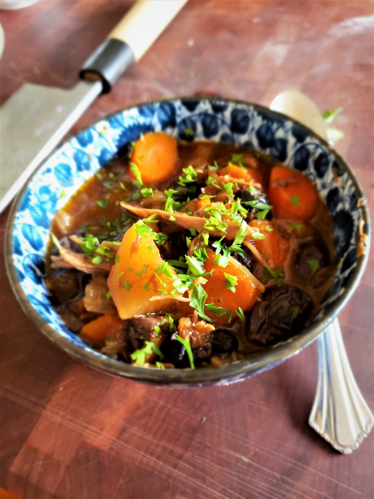 A bowl of lamb stew with vegetables