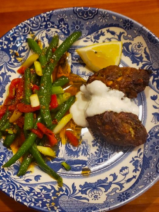 lamb koftas with yogurt dressing served with sweet and spicy green beans